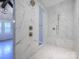 Luxurious walk-in shower with marble tile, overhead rainfall shower head, and a built-in bench at 9426 Greyson Ridge Dr, Charlotte, NC 28277
