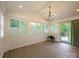 Bright sunroom featuring light wood floors and white wood paneling at 9426 Greyson Ridge Dr, Charlotte, NC 28277