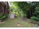 Landscaped backyard features a wooded perimeter, a wooden staircase, and lawn at 9900 Colvard Cir, Charlotte, NC 28269