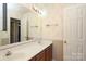 Bathroom with floral wallpaper, double vanity and a large mirror at 9900 Colvard Cir, Charlotte, NC 28269