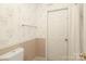 A quaint bathroom features floral wallpaper and a white door at 9900 Colvard Cir, Charlotte, NC 28269