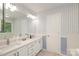 Bright bathroom with double vanity, quartz countertop, and white cabinetry at 9900 Colvard Cir, Charlotte, NC 28269