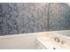Elegant bathroom with decorative wallpaper, modern vanity, and spacious mirror at 9900 Colvard Cir, Charlotte, NC 28269