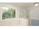 Bathroom featuring large window, tub and separate glass enclosed shower at 9900 Colvard Cir, Charlotte, NC 28269