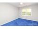 Neutral bedroom with window and blue carpet at 9900 Colvard Cir, Charlotte, NC 28269