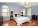 Charming bedroom featuring vaulted ceiling, arched windows, and wood floors at 9900 Colvard Cir, Charlotte, NC 28269