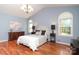 Elegant bedroom with vaulted ceiling, chandelier, and rich wood floors at 9900 Colvard Cir, Charlotte, NC 28269