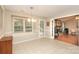 Open dining room with large window, view to brick fireplace and tiled floor at 9900 Colvard Cir, Charlotte, NC 28269