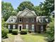 Traditional brick home with manicured lawn, black shutters, and well maintained landscaping at 9900 Colvard Cir, Charlotte, NC 28269