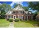 Charming two-story brick home with black shutters, manicured landscaping and beautiful lawn at 9900 Colvard Cir, Charlotte, NC 28269