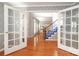Open foyer featuring hardwood floors, french doors, and stairs with blue carpet at 9900 Colvard Cir, Charlotte, NC 28269