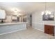 Open kitchen with white cabinets, stainless steel appliances, and large island at 9900 Colvard Cir, Charlotte, NC 28269