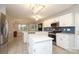 Open kitchen with stainless steel appliances, white cabinets, and an island with seating at 9900 Colvard Cir, Charlotte, NC 28269