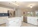 Spacious kitchen featuring white cabinets, stainless steel appliances, and a central island at 9900 Colvard Cir, Charlotte, NC 28269
