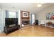 Cozy living room with a brick fireplace, vaulted ceiling, and lots of natural light at 9900 Colvard Cir, Charlotte, NC 28269