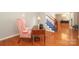 Home office featuring hardwood floors, vintage desk, chair and view to stairs in a light filled room at 9900 Colvard Cir, Charlotte, NC 28269