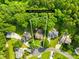 Aerial view of a property on a well-manicured lot surrounded by mature trees at 10908 Delsing Ct, Charlotte, NC 28214