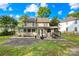 Spacious backyard with patio seating, a fire pit, and partially fenced perimeter at 10908 Delsing Ct, Charlotte, NC 28214