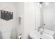 Cozy powder room with a white vanity, decorative hand towels, and a wall mounted decorative art piece at 10908 Delsing Ct, Charlotte, NC 28214