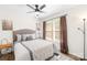Cozy bedroom featuring a ceiling fan, large window, and neutral-toned decor at 10908 Delsing Ct, Charlotte, NC 28214