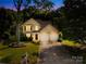 Charming two-story home with a well-maintained lawn, mature trees, and an inviting entrance at 10908 Delsing Ct, Charlotte, NC 28214