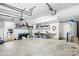 Spacious garage with overhead storage and room for multiple vehicles at 10908 Delsing Ct, Charlotte, NC 28214