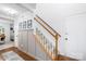 Hallway with staircase leading upstairs and access to the dining room, featuring a clean and classic design at 10908 Delsing Ct, Charlotte, NC 28214