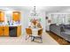 Eat-in kitchen with dining table and chairs adjacent to living room with gray sectional sofa at 10908 Delsing Ct, Charlotte, NC 28214