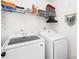 Modern laundry room with white appliances, storage shelves, and organized supplies at 10908 Delsing Ct, Charlotte, NC 28214