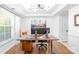 Bright home office with large windows, modern lighting, and a spacious desk area at 10908 Delsing Ct, Charlotte, NC 28214