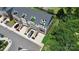 A bird's-eye view showing townhouses with rooftop terraces, lush landscaping, and ample parking at 11043 Stetler St, Charlotte, NC 28204