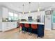 Well-lit kitchen featuring white cabinets, a central island with seating, and stainless steel appliances at 11043 Stetler St, Charlotte, NC 28204