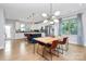 Bright, open kitchen with white cabinets, a navy blue island, and a dining area with modern lighting at 11043 Stetler St, Charlotte, NC 28204