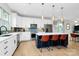 Bright kitchen with white cabinets, a navy blue island, stainless steel appliances, and barstool seating at 11043 Stetler St, Charlotte, NC 28204