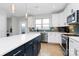 Modern kitchen with white cabinets, a stainless steel dishwasher and stove, and an island with seating at 11043 Stetler St, Charlotte, NC 28204