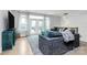 Cozy living room features a plush gray sofa, a view from the doors and a modern light fixture at 11043 Stetler St, Charlotte, NC 28204