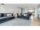 Spacious living area featuring a gray sectional sofa, a view to the kitchen, and modern decor at 11043 Stetler St, Charlotte, NC 28204