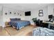 Comfortable main bedroom with hardwood floors, tv, desk, and floral pattern bedding at 11043 Stetler St, Charlotte, NC 28204