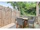 Cozy outdoor seating area with a wooden fence and string lights surrounded by lush greenery at 11043 Stetler St, Charlotte, NC 28204
