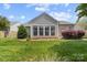 View of backyard featuring lush lawn, manicured landscaping, and privacy fence at 1107 Rachel Anne Dr, Belmont, NC 28012