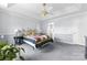 Inviting main bedroom featuring a tray ceiling, neutral walls, and cozy carpet at 1107 Rachel Anne Dr, Belmont, NC 28012