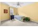 Cozy bedroom featuring a ceiling fan and a light-filled window, complete with comfortable carpeting at 1107 Rachel Anne Dr, Belmont, NC 28012