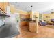 Bright kitchen with wooden cabinets seamlessly leading into the adjacent living area at 1107 Rachel Anne Dr, Belmont, NC 28012