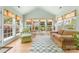 Inviting sunroom with vaulted ceiling, multiple windows and neutral decor at 1107 Rachel Anne Dr, Belmont, NC 28012