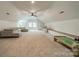 Large bonus room boasts a ceiling fan, natural light, and ample space for relaxation and entertainment at 1121 S Wendover Rd, Charlotte, NC 28211