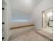 Bright attic room with a built in bench and carpet, leads into bathroom at 1121 S Wendover Rd, Charlotte, NC 28211