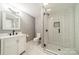 Updated bathroom features a sleek vanity, modern fixtures, and a glass-enclosed shower at 1121 S Wendover Rd, Charlotte, NC 28211