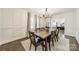 Formal dining room featuring hardwood floors, decorative wainscoting, and a stylish chandelier at 1121 S Wendover Rd, Charlotte, NC 28211