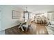 Open-concept dining area showcasing a rustic table, modern lighting, and seamless flow to the kitchen at 1121 S Wendover Rd, Charlotte, NC 28211