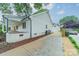 Charming home with white siding, well-manicured landscaping, and a long driveway at 1121 S Wendover Rd, Charlotte, NC 28211